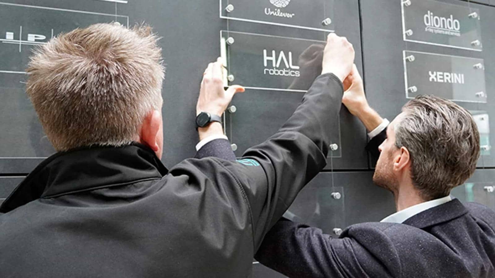 MTC members hanging a plaque