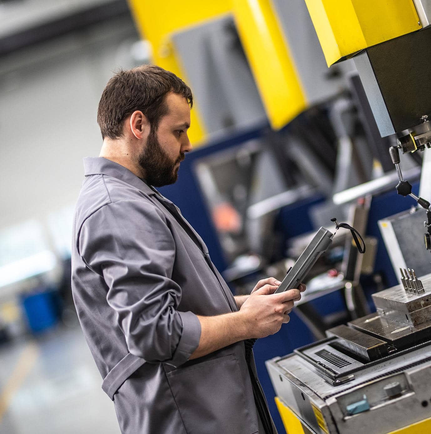 Engineer using digital screen in production