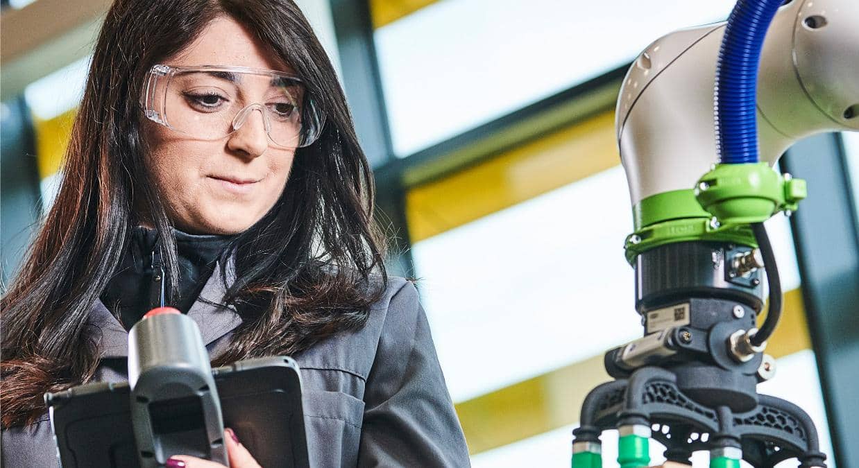 Engineer using a robot arm